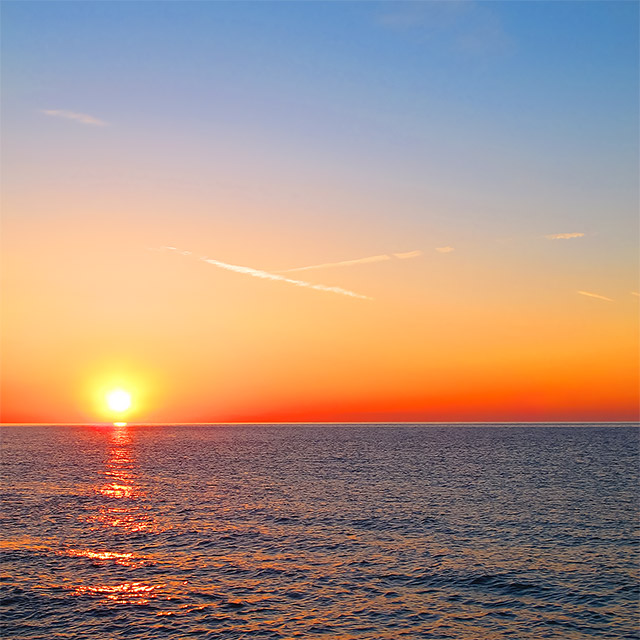 Sunrise on the sea at Cala Ginepro, in Sardinia