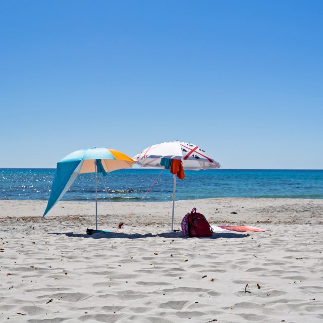 Two parasols by the sea, in Sardinia